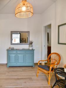 a room with a blue dresser with a mirror and a chair at Il Giardino di Eva - Holiday Home - intero alloggio in Solferino