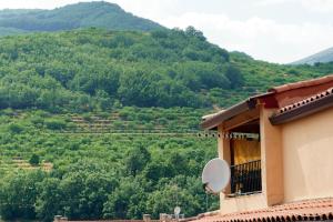 a house with a satellite dish on a mountain at Apartamento La Pina in Cabezuela del Valle