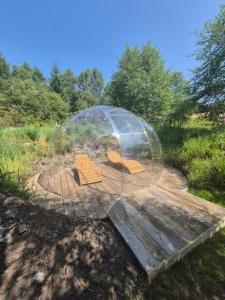 a dome with boxes inside of it in a field at Little Getaway in the Highlands, private sauna and stargazing geodome in Garve +16 photos