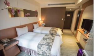 Postel nebo postele na pokoji v ubytování Ximen Relite Hotel
