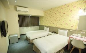 Postel nebo postele na pokoji v ubytování Ximen Relite Hotel