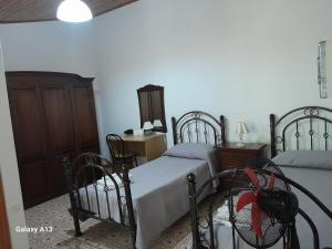 a bedroom with two beds and a dresser at Antichi Sapori da Speranza in Gavoi