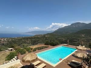 a swimming pool with umbrellas and a view of the ocean at Euphoria Estate Messinia in Avía