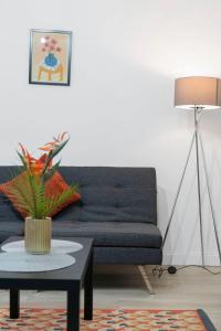 a living room with a blue couch and a table at Free Parking - Sleeps 6 - Central - New Interior in Greenock