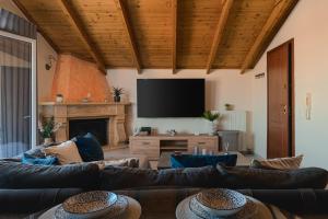 a living room with couches and a flat screen tv at Meltemi apts Charming Penthouse in Zakynthos Town