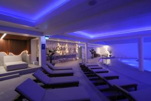 a room with a swimming pool and a room with purple lighting at Grand Lubicz Uzdrowisko Ustka in Ustka