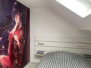 a bedroom with a painting of a woman on the wall at Confortable Appartement près de Metz pour 6 personnes in Ban-Saint-Martin