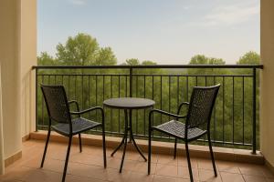 a table and two chairs on a balcony at Beach Resort Paradise Bungalows in Trincomalee