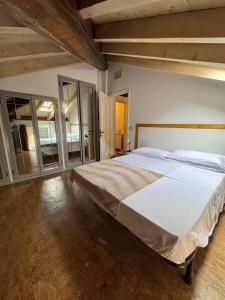 a large bedroom with a large bed with white sheets at Residence Armonia in Boario Terme