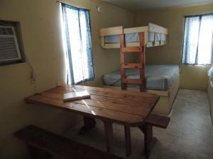 a room with a desk and a bunk bed at O'Connell's RV Campground Studio Cabin 1 in Inlet