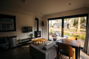 a living room with a couch and a table at Holiday Home Maridu Wellness in Arnhem
