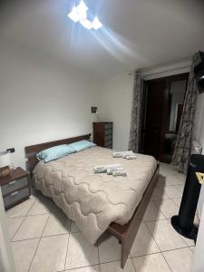 a bedroom with a large bed in a room at Montecarlo house vacation in Luino