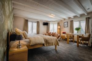 a bedroom with a large bed and a living room at Bariseele B&B in Bruges