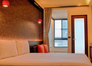 Postel nebo postele na pokoji v ubytování 嬉安平 Si Anping by Hotel Si
