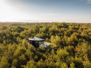 an aerial view of a house in the middle of a forest at Dharma Resort in Rässa