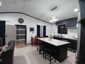 a kitchen and dining room with a table and chairs at Silagi Holiday Home in Nadi