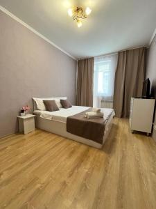a bedroom with a bed and a television in it at EmmaApart Comfort 169 in Astana