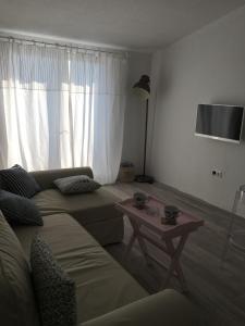 a living room with a couch and a table at Apartment Vela in Neum