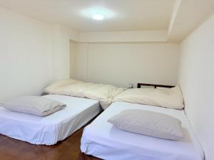 Postel nebo postele na pokoji v ubytování 西山ハウス101