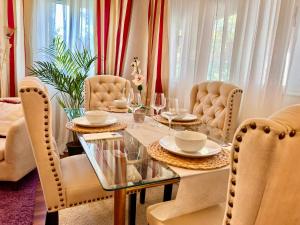 a dining room with a table and chairs with wine glasses at Casa La Tabierna Suances - Monabri in Suances