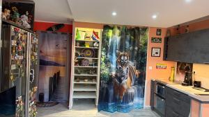 a kitchen with a painting of a horse on the wall at Résidence haut de gamme - 45m2 refait à neuf en mai 2026 avec très grande piscine chauffée in Cap d'Agde