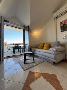 a living room with a couch and a table at Apartment Luxury B Vodice in Vodice