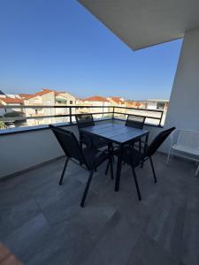 a table and chairs on a balcony with a view at Apartment Luxury B Vodice in Vodice +18 photos