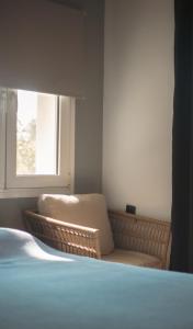 a bedroom with a chair and a window at Nice & Cozy Apartments in Alexandroupoli