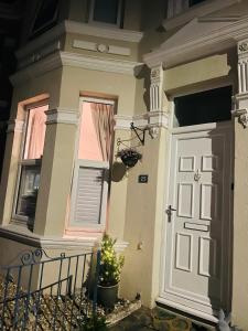 a house with a door and a christmas tree in front at Peverell Loft Retreat in Plymouth