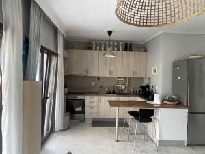a kitchen with a table and a refrigerator at J&J Seaview Apartment in Ofrínion