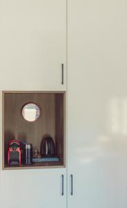 a white cabinet with a light on top of it at Nice & Cozy Apartments in Alexandroupoli +47 photos