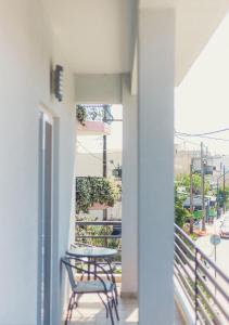 a table and a chair on a balcony at Nice & Cozy Apartments in Alexandroupoli