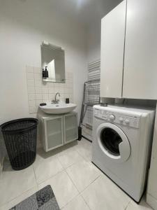 a bathroom with a washing machine and a sink at La légende Men Marz 1er étage- Centre-ville Brignogan-Plages , 300 m des plages in Brignogan-Plages