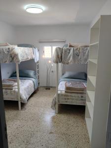 a bedroom with two bunk beds and a window at Guesthouse Los Geranios in Mocanal