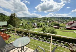 a view from the balcony of a house with a table and chairs at Pokoje i apartamenty Ferencówka Bieszczady in Zawóz +27 photos