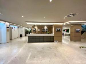 a lobby with a reception desk in a building at Hotel Apartamentos Fuengirola private studio in Fuengirola +19 photos