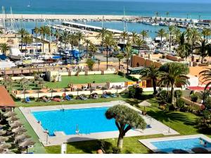 a view of a resort with a pool and a marina at Hotel Apartamentos Fuengirola private studio in Fuengirola
