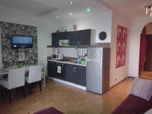 a kitchen with a table and a white refrigerator at Casa sul mare in Alba Adriatica