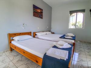 a room with two beds and a window at Kanali Apartments in Kanali