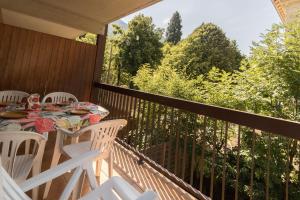a table and chairs on a balcony with a view at Vacances cures luchon in Luchon