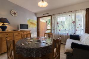 a living room with a table and a couch at Vacances cures luchon in Luchon