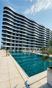a large apartment building with a large swimming pool at Mamaia Luxury Studio Apartment T in Mamaia