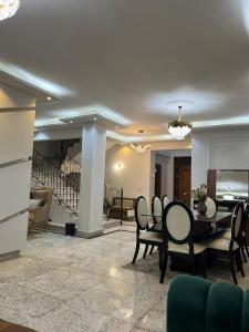 a living room with a dining table and chairs at Villa waterway 2 in Cairo