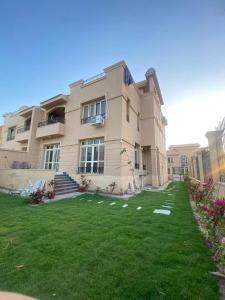 a large building with a lawn in front of it at Villa waterway 2 in Cairo