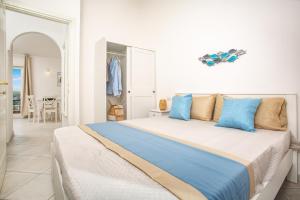 a bedroom with a large bed with blue pillows at BILANCIA V 30' Porto Cervo & PRIVATE TERRACE with SEA VIEW in Porto Pozzo +37 photos