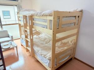 a couple of bunk beds in a room at 西山ハウス204 in Nagasaki