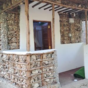 a house with a door in the side of it at JozaniBiospherevillage in Jozani
