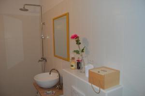 a white bathroom with a sink and a mirror at Apartment Vela in Neum +19 photos