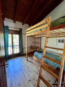 a bedroom with two bunk beds and a ladder at Apartamento Margalida en Cerler, Pirineo Huesca in Cerler