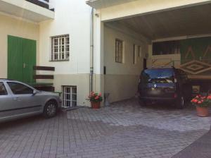 two cars parked in a garage next to a building at Gadenstätter Apartments in der City in Zell am See